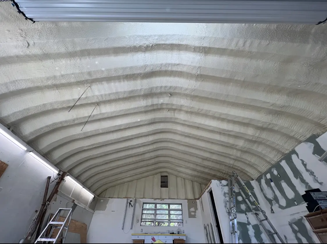 Spray polyurethane foam applied to the underside of a metal roof deck in Alcoa